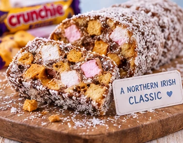 Coconut-coated Crunchie Fifteens slices with visible marshmallow and chocolate-coated honeycomb pieces.